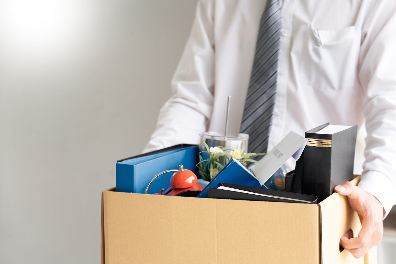 man with items from his desk packed into a box