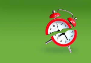 red alarm clock broken in half