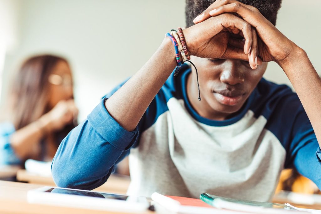 Young Man tired with elbows on desk