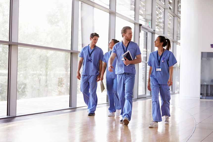 Health professionals walk in a corridor