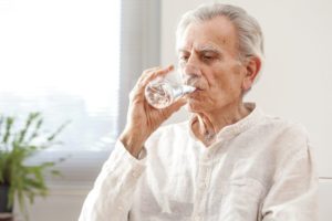 stock photo of an older man drinking water