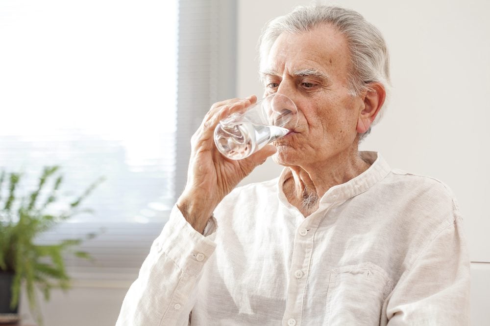 stock photo of an older man drinking water