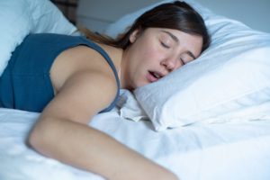 woman snoring in bed