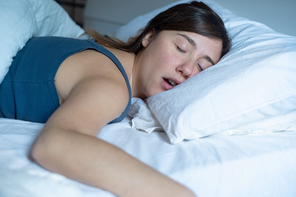 woman snoring in bed