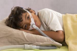 stock photo of a child using a cpap machine