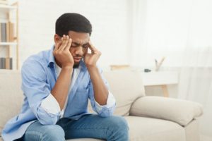 stock photo of a young man with a headache