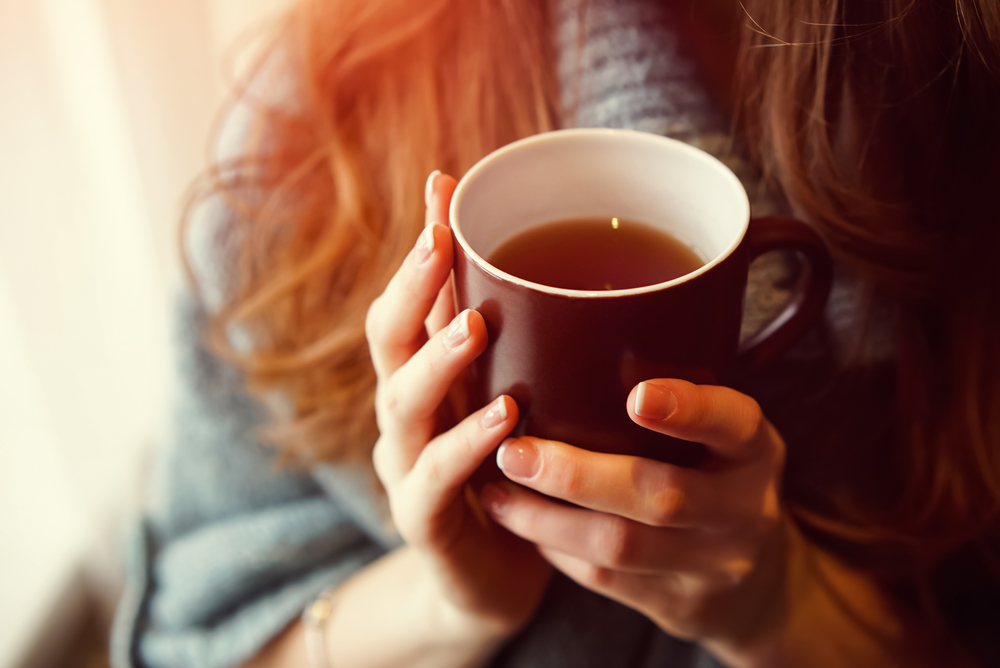 stock photo of a woman holding a cup of tea