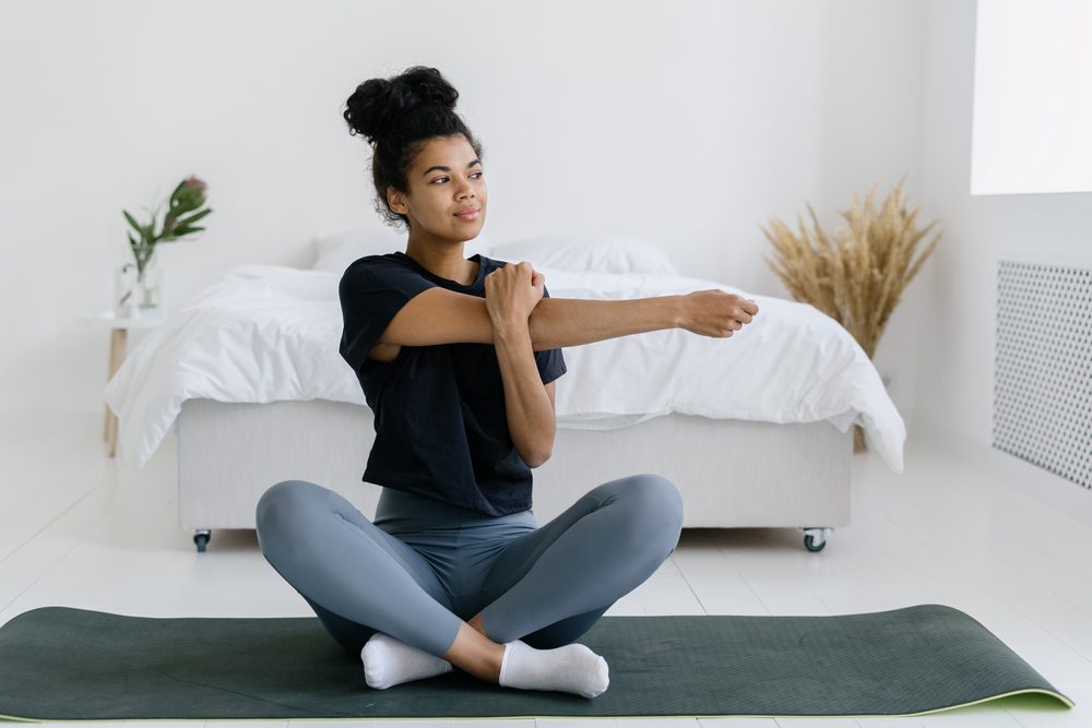 stock photo of a young woman stretching her arm