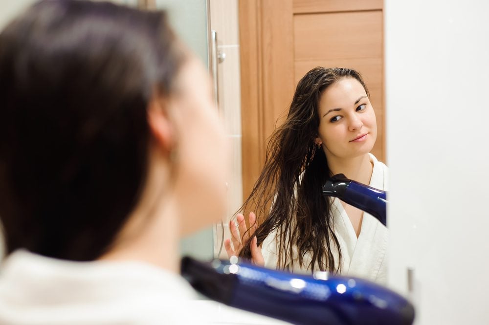 stock photo of a woman drying her hair