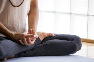 A person with their legs crossed in a meditative pose
