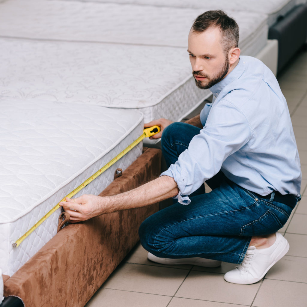 Person measuring a queen size bed