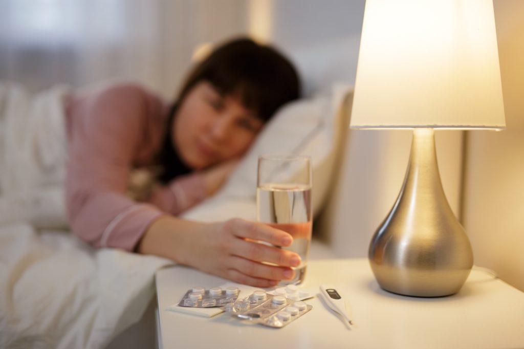 Woman taking nighly melatonin