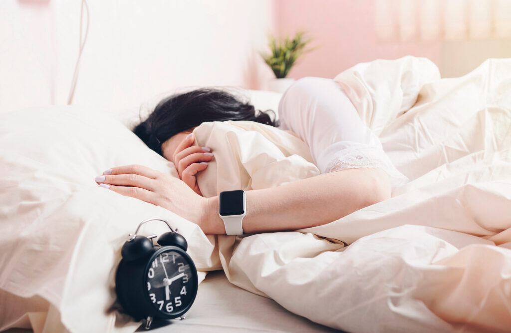 A person sleeps while wearing an apple watch