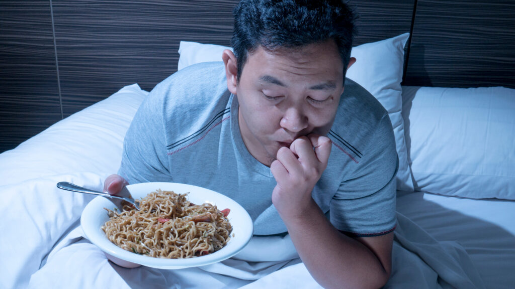 a man contemplates a nighttime snack