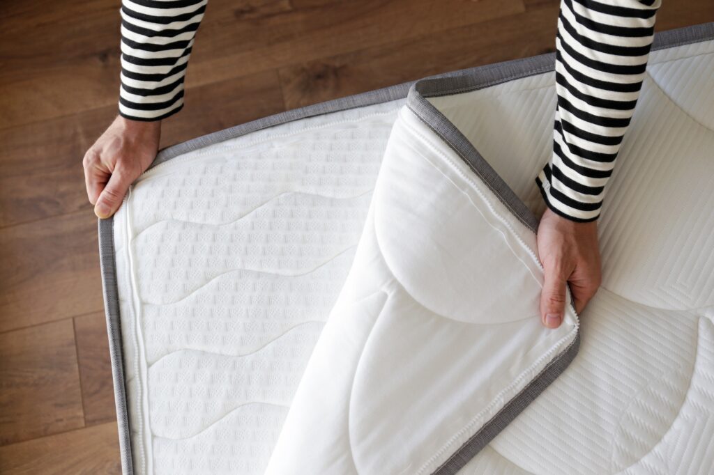 Man shows a mattress protector