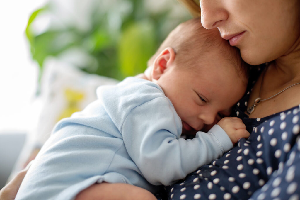 A woman holds a newborn