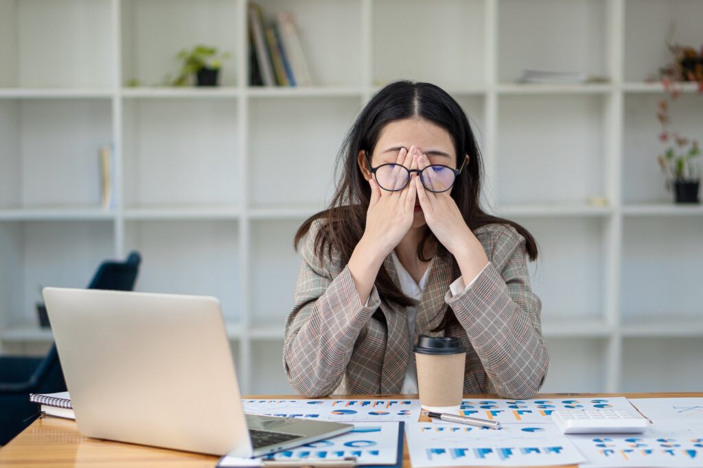 a woman who is overtired rubs her eyes