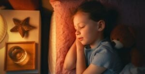 Little girl sleeping with a warm yellow light on