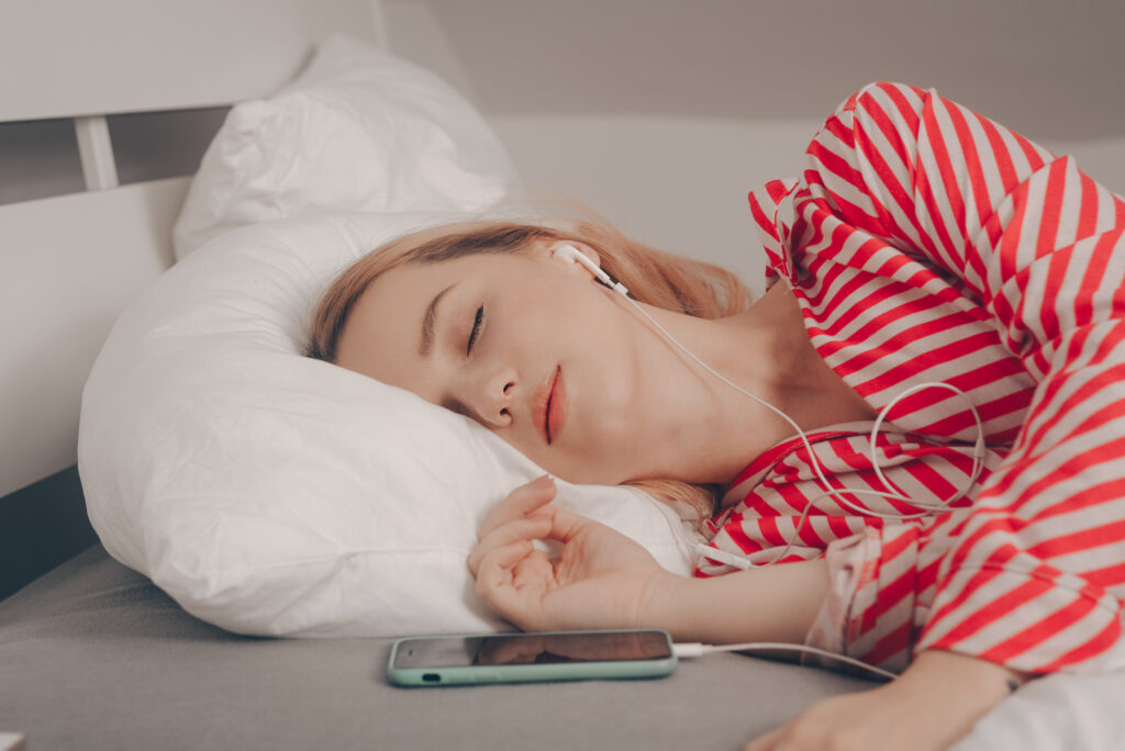A woman listens to podcasts to help sleep