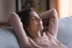 A woman practices sleep affirmations to relax before bed