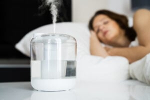 A humidifier being used in a bedroom