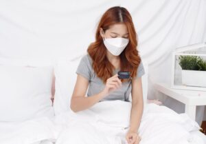 A woman tests her blood oxygen levels