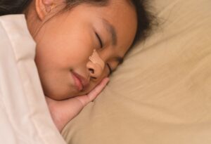 A person sleeping with a nasal strip