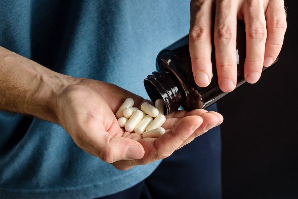 man taking testosterone supplements