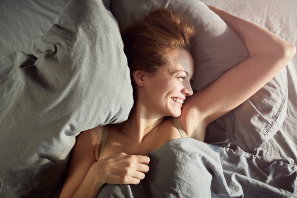 person waking up with a smile