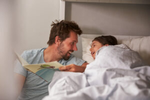 parent reading to child before bed