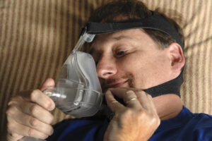 man happy to be using CPAP device