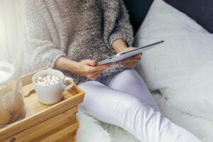 person uses a tablet in the evening