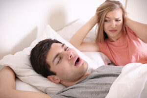 image of a couple, with one person snoring