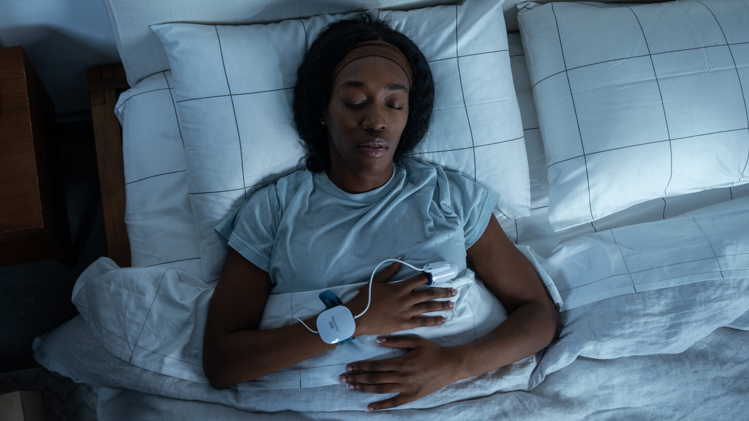 A woman wearing a WatchPat ONE sleep test.